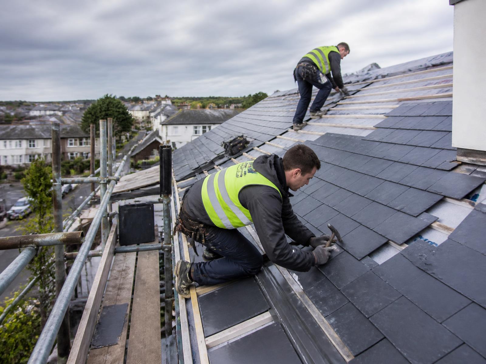 ProLine roofers installing a slate roof at golden hour